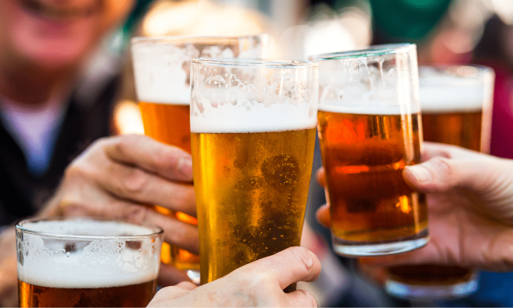 This is an image of people clinking their pints together.
