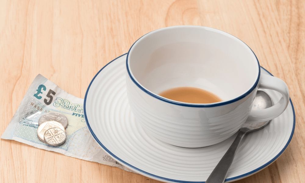 Important things to know London: This is an image of an empty tea cup with £5 underneath.