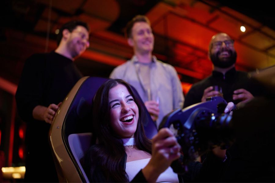 A girl having a good time at the F1 arcade in London. Enjoy the best of the city's activities listed in our London itinerary
