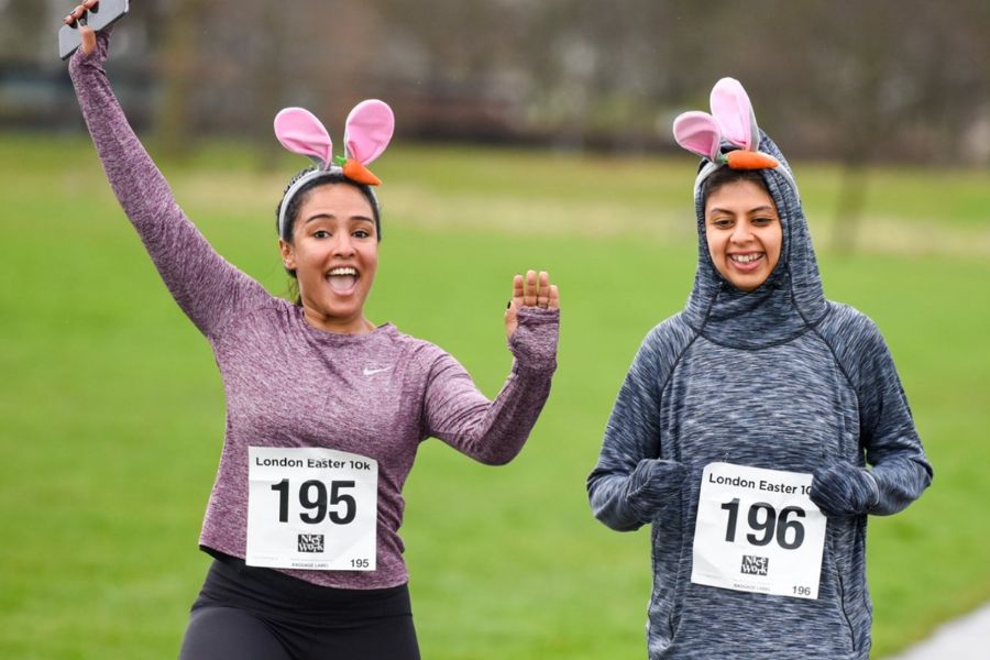 This is an image of two people wearing bunny ears and a 10km race bib.