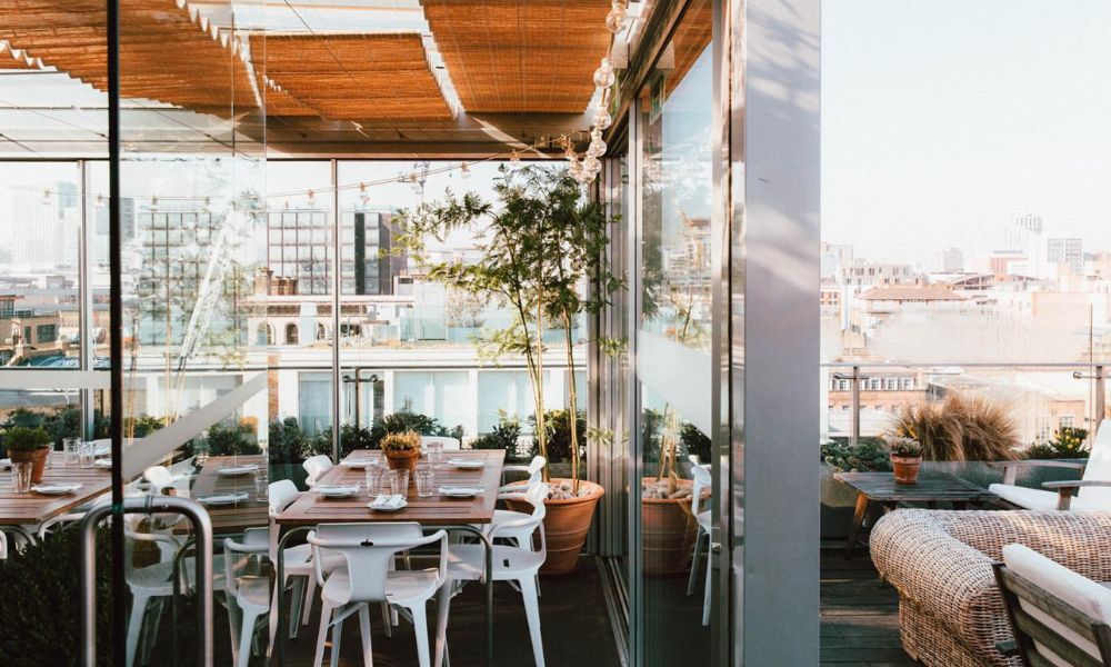 This refurbished warehouse now has a really chic rooftop in East London with couches and tables.