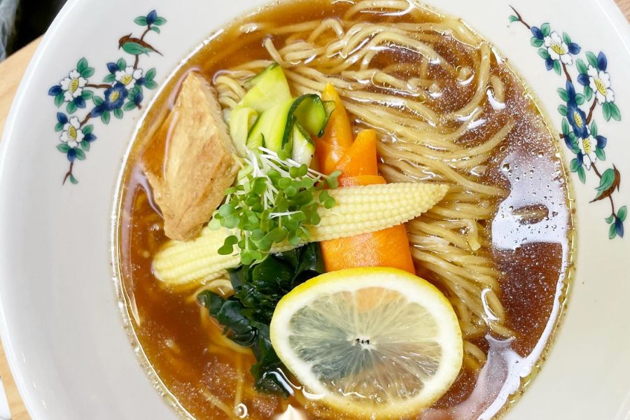 This is an image of a noodle and veggie bowl in a pretty plate.