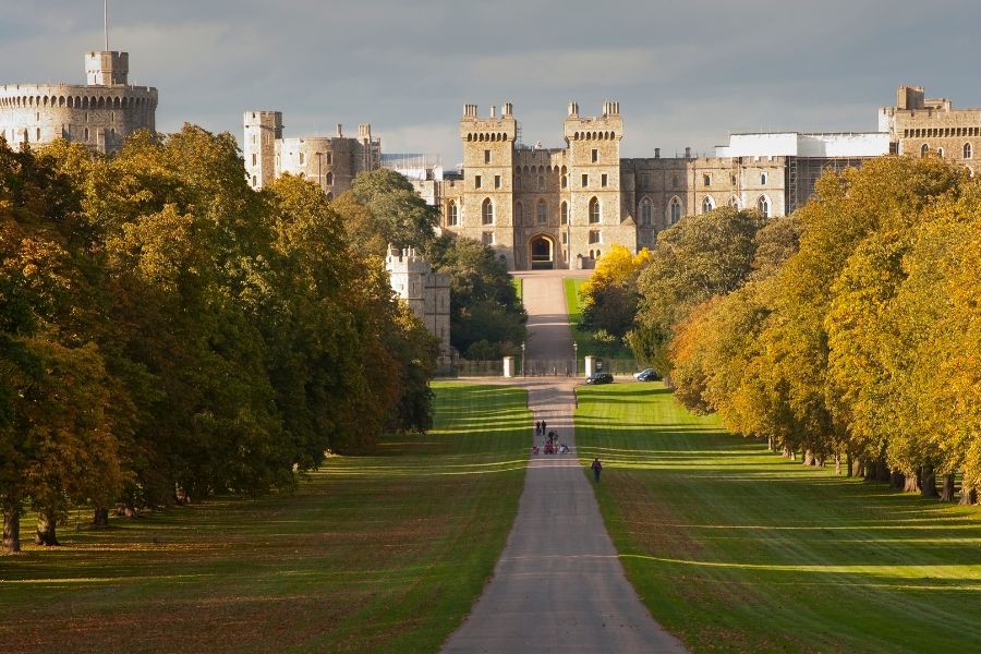 A view down the Long Walk towards Windsor Castle, flanked by tree-lined green parkland on either side