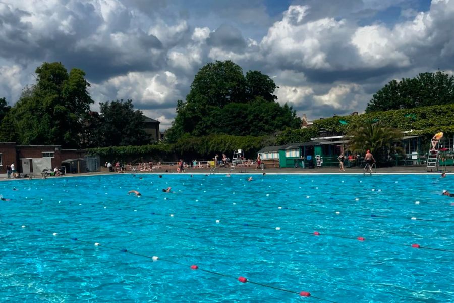 This is an image of Brockwell Lido public pool with lanes of swimming and greenery.