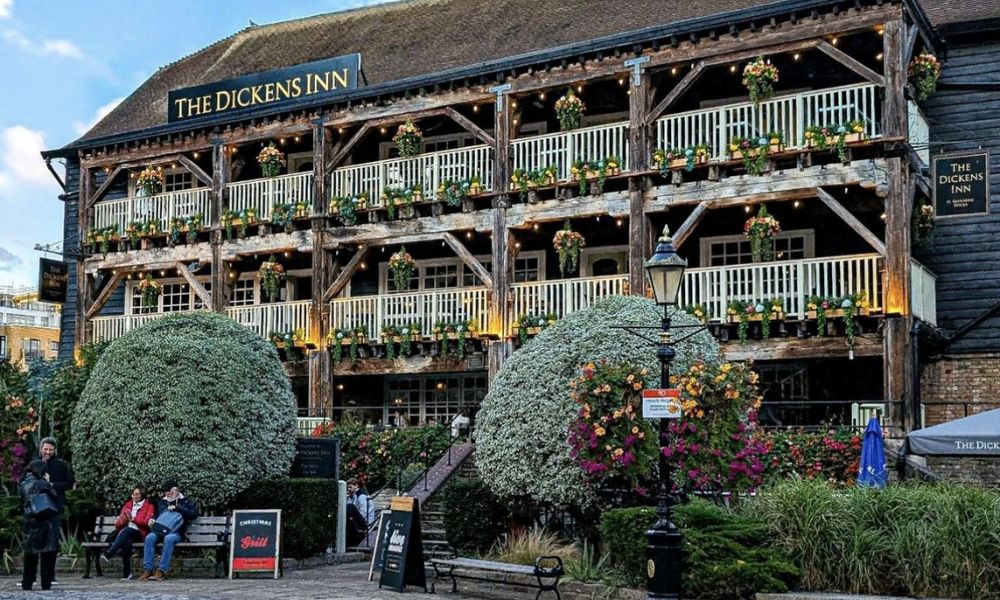 This is an image of a big wooden mansion house with two levels and a balcony.