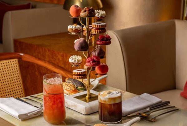 Unique afternoon teas in London: This is an image of a tiered stand with delicious drinks and artsy cakes.