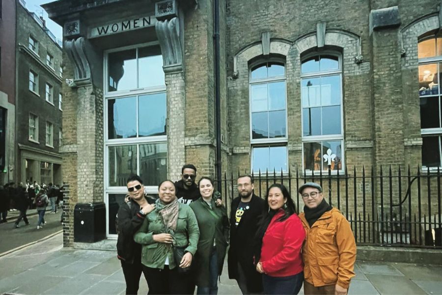 This is an image of a group of people in front of a building that says 'Women' as part of the women-focused Jack The Ripper tour.