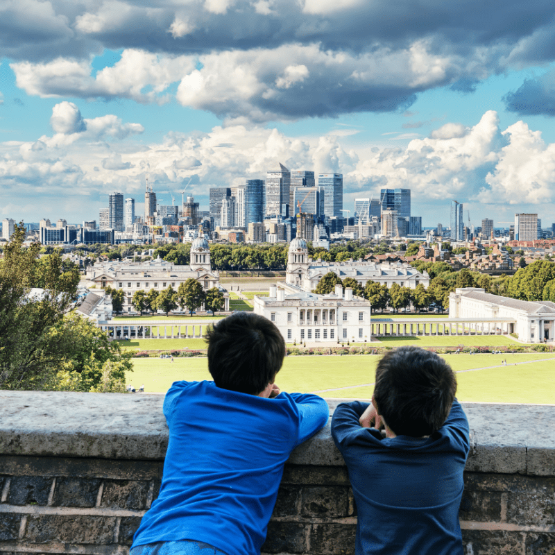 Children enjoying the view of Royal Naval College and Canary Wharf from the ROyal Observatory
