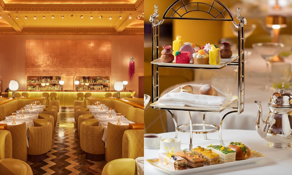 This is an image of a mustard-coloured, orange room with cosy, nicely-set afternoon tea tables. To the right is a two-tiered cake stand and a plate of sandwiches.