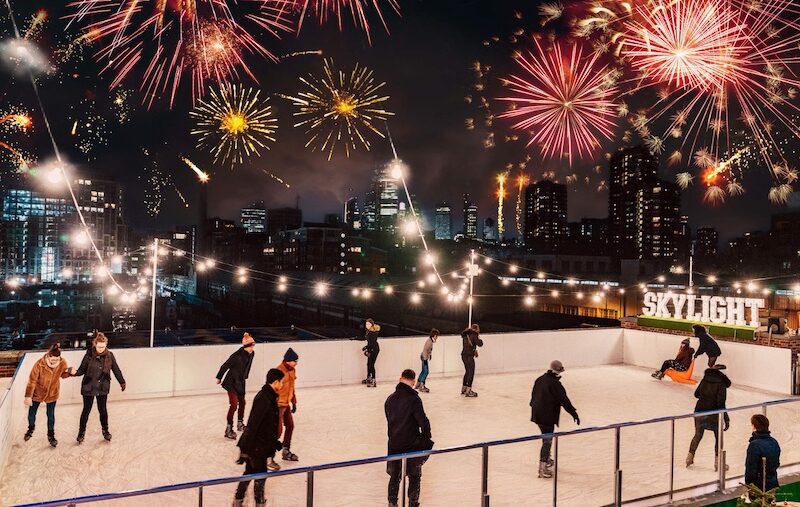 Fireworks overlooking the ice rink at Skylight Docks; going ice skating with your loved ones is one of the top things to do in London on Christmas eve
