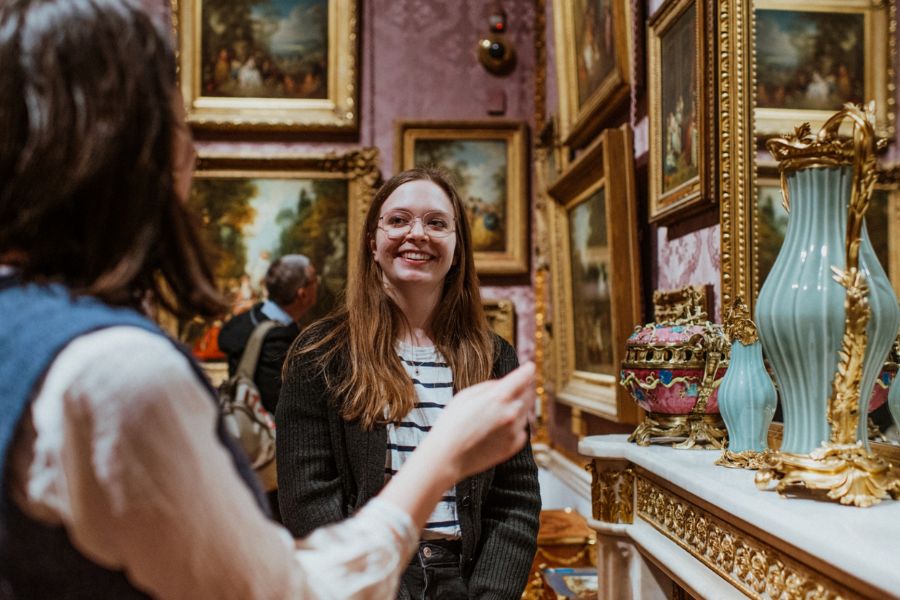 This is an image of a lady showing another woman around the Wallace Museum.