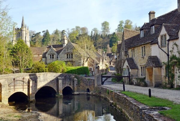 This is an image of a lovely cobblestone village with old houses lining the streets.