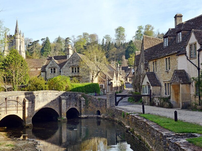 This is an image of a lovely cobblestone village with old houses lining the streets.