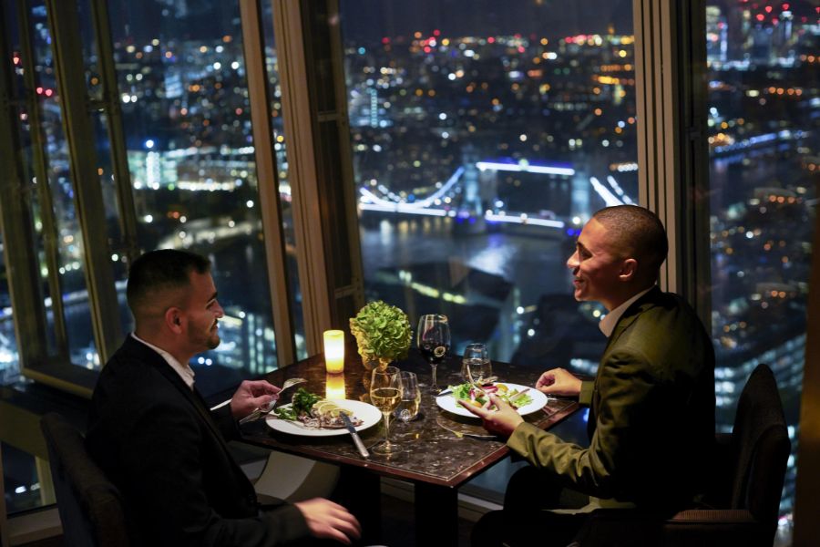 Two men having dinner with a view at The Shard. Pre booking restaurants is how you can maximise your time when visiting London