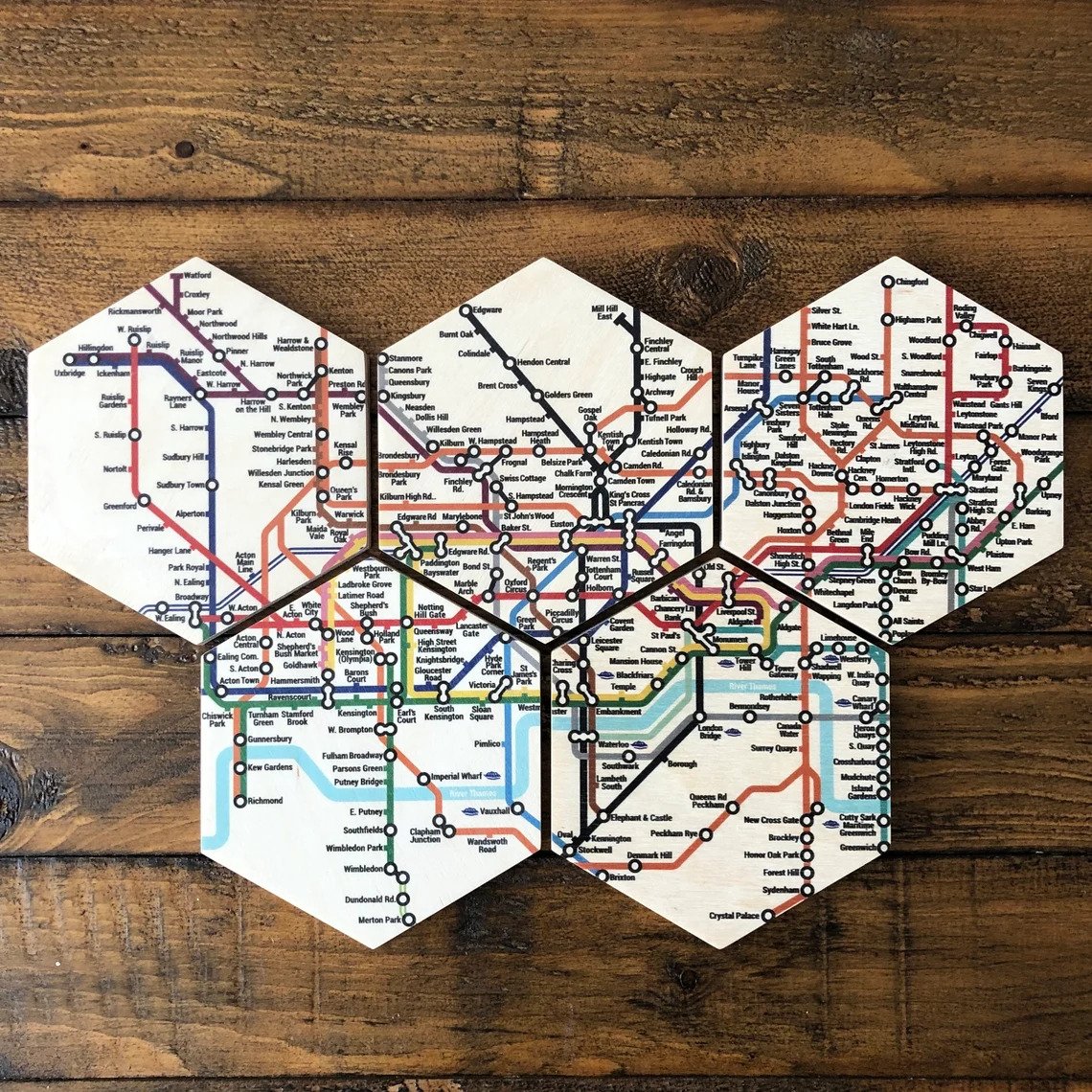 London Tube Map coasters on a wooden table.