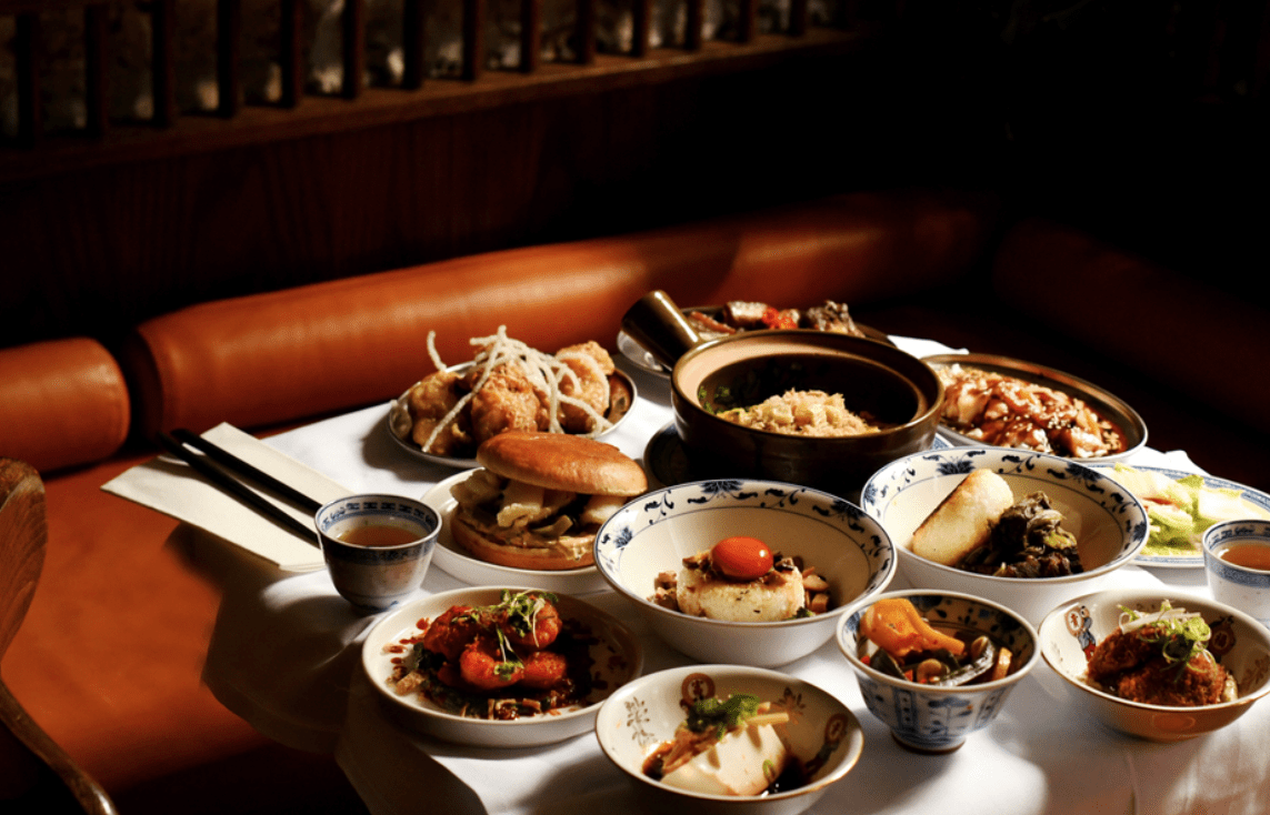 Image of delicious plates of food laid out on a neatly prepared dinner table at Bun House restaurant in London