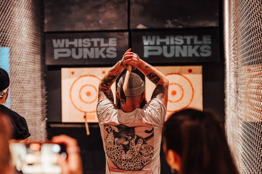 Man throwing an axe during one of the games at Whistle Punks. This is one of the best things to do in London if you love sports