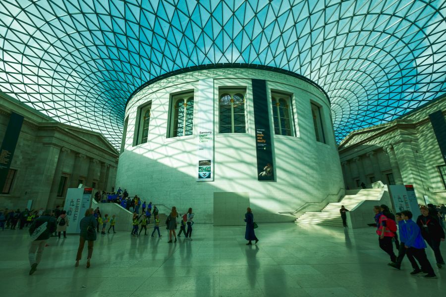 The majestic British Museum atrium welcomes visitors on a sunny day; this museum even includes the best guided tours of London attractions, which is also interactive