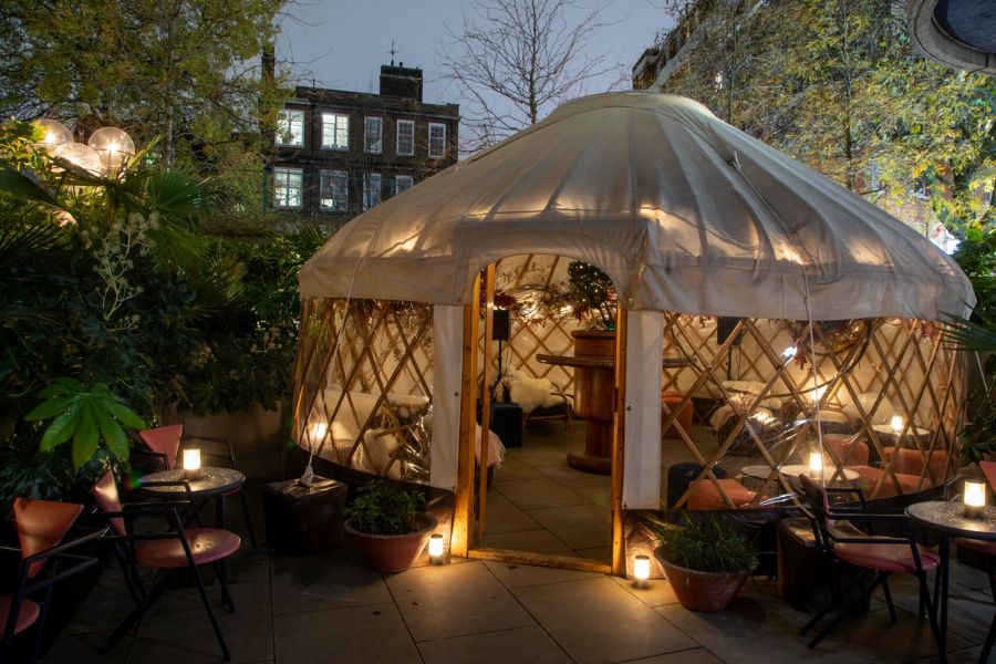 This is an image of a little outdoor rooftop canopy decorated for Christmas time.