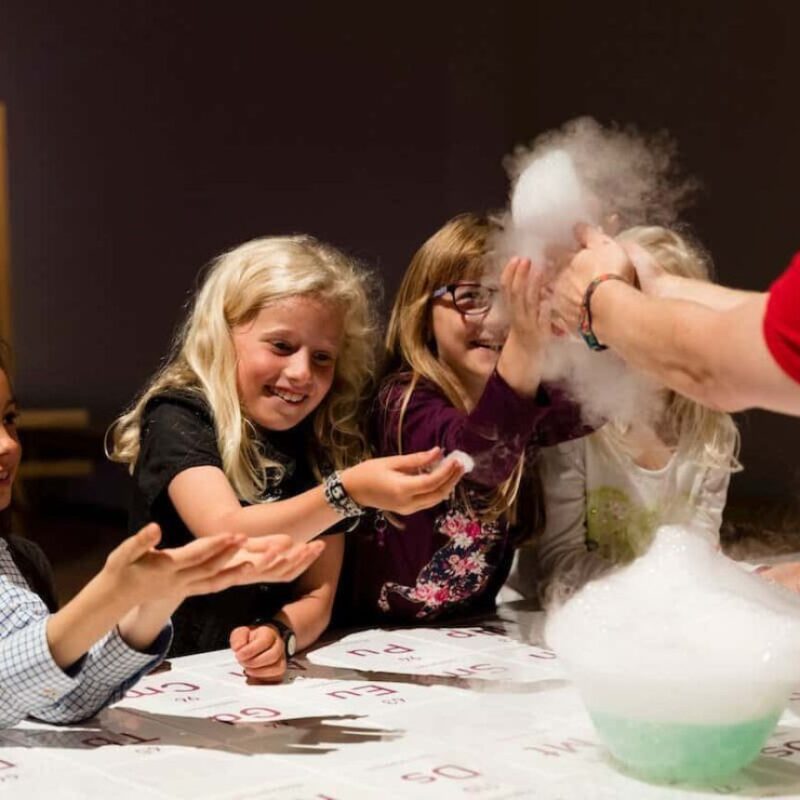 Children having fun doing a science experiments during one of the top London kid-friendly tours