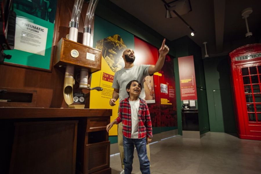 Father and son enjoying their time at the London Postal Museum during on of the top kid-friendly London Tours
