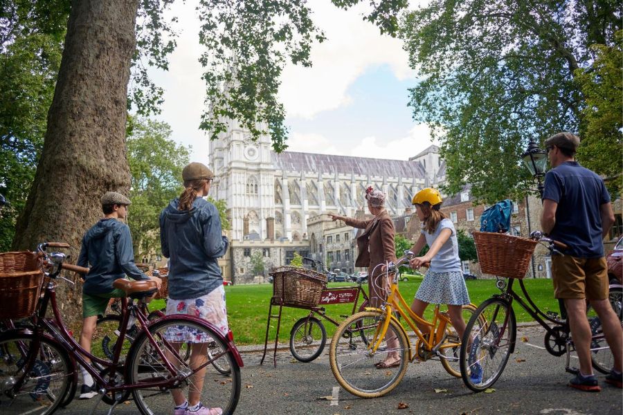 Kids learning about the history of Westminster Abbey during the Vintage Bike Tour of London landmarks
