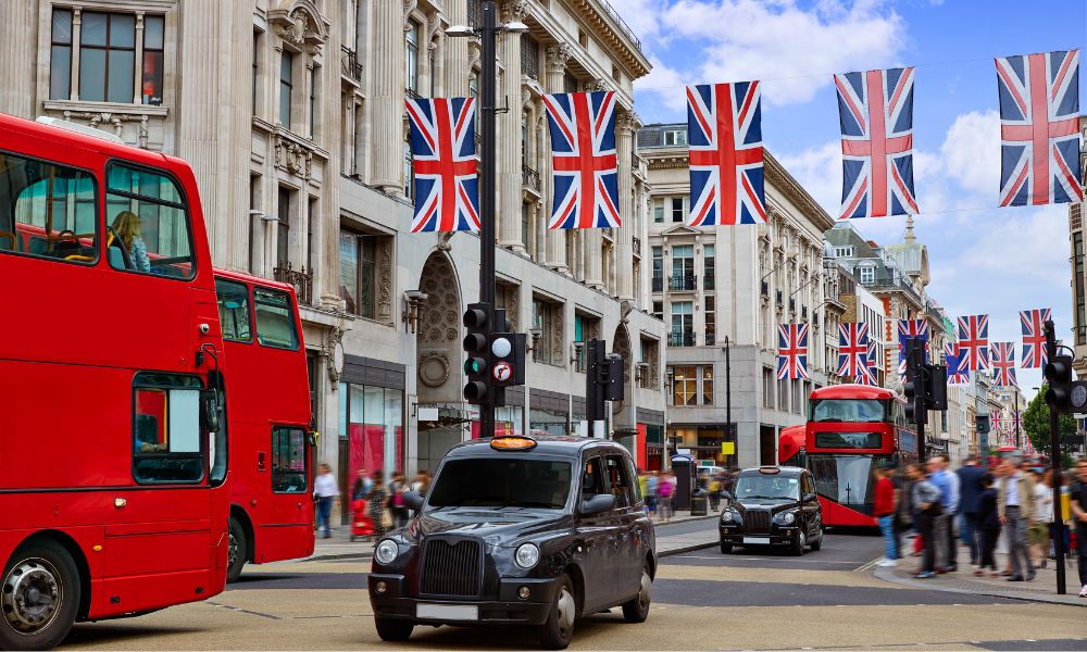 This is an image of Oxford Street on a sunny day with British flag lining the streets.