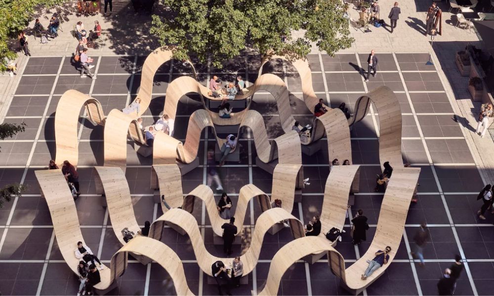 This is an image of cool seating art work that is a swirly wooden material that looks almost like human-size pencil shavings.