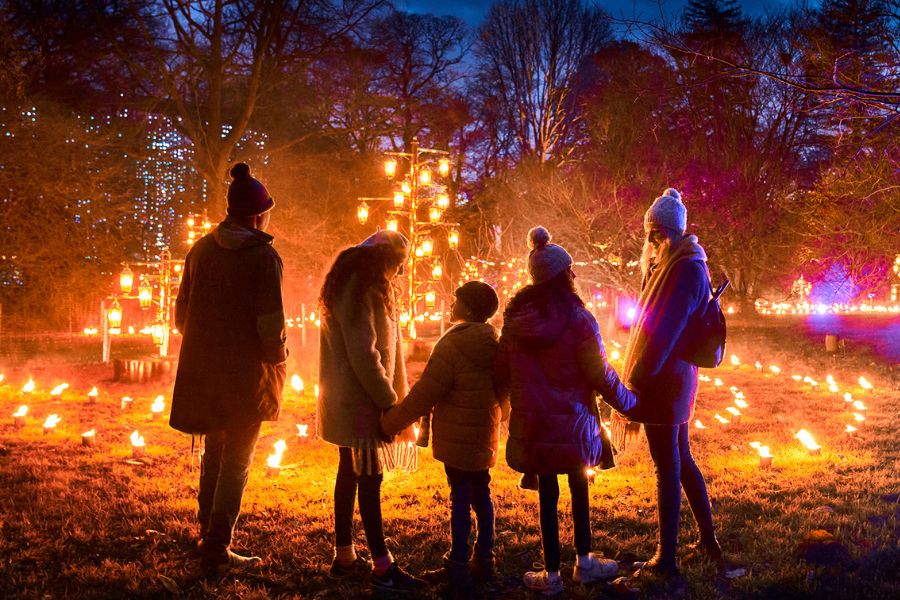 Friends on a light trail at Kew Gardens; this is one of the best ways to experience christmas lights in London
