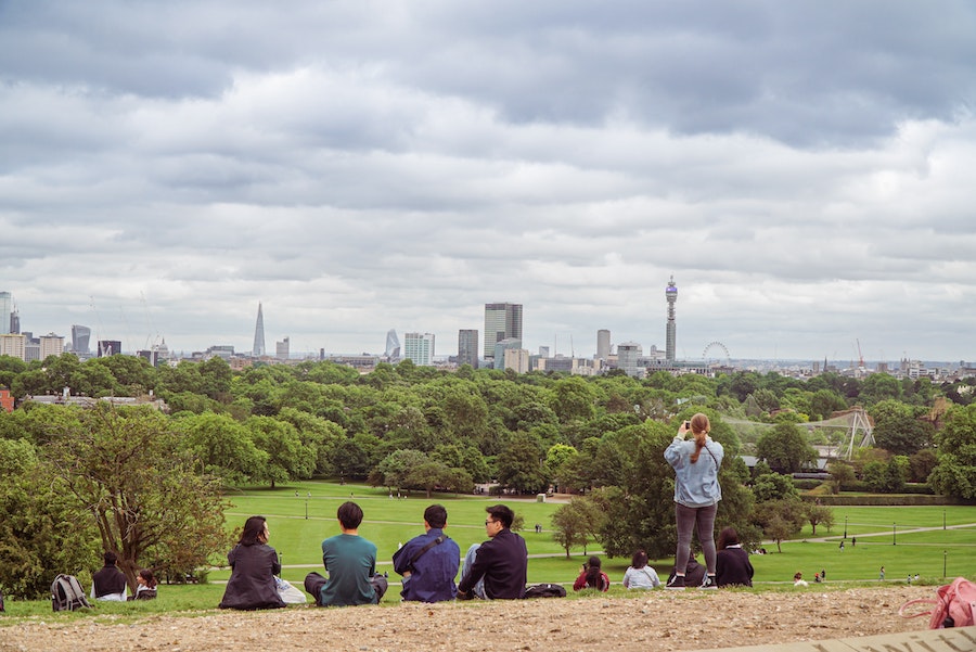 People enjoying the beautiful London skyline from Primrose Hill.