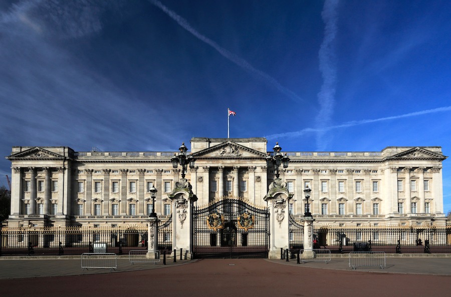 This is an image of a palace facade. It is big and grand and has a light colour to its stone walls. The sky is a deep vivid blue and is cloudless. There are no people in sight.