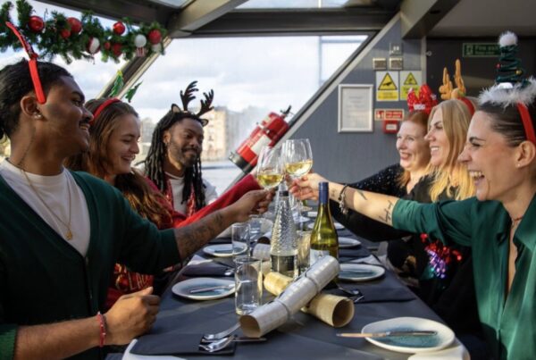 This is an image of a group of people cheersing over a festive table.