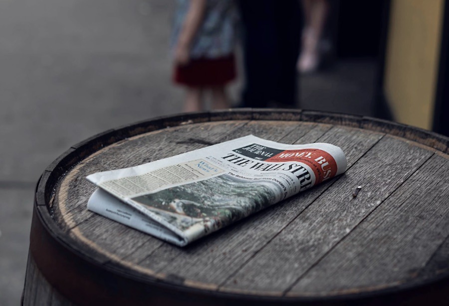 This is an image of a folded-over newspaper on a barrel. A common tourist scam in London is when scammers put a newspaper over your phone and steal it.