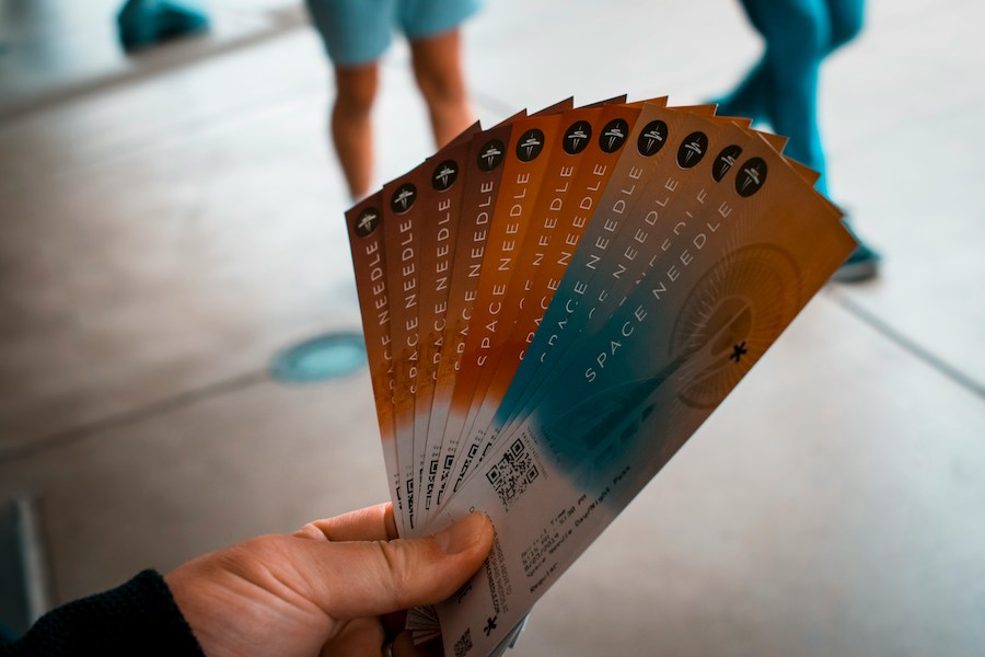 This is an image of a man holding a fan of tickets. Buying tickets on the street is a common scam when visiting London.