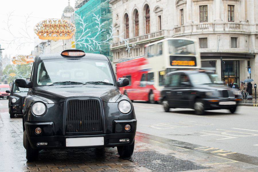 This is a picture of a taxi driving through Central London.