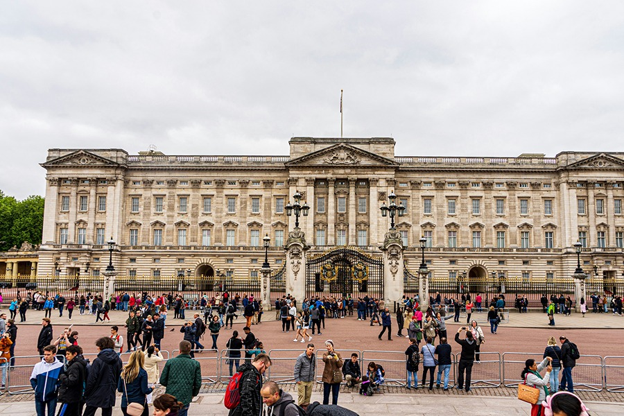 Buckingham Palace with visitors gathered outside, one of the famous London sights to include in your Explorer Pass plans.