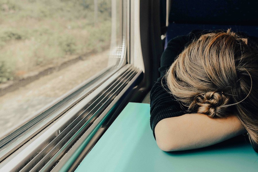 This is an image of a lady sleeping on the train.