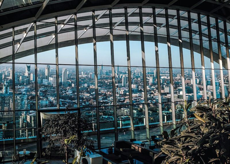 This is an image of the view you get from Sky Garden of London City. There are lots of buildings and plants around.