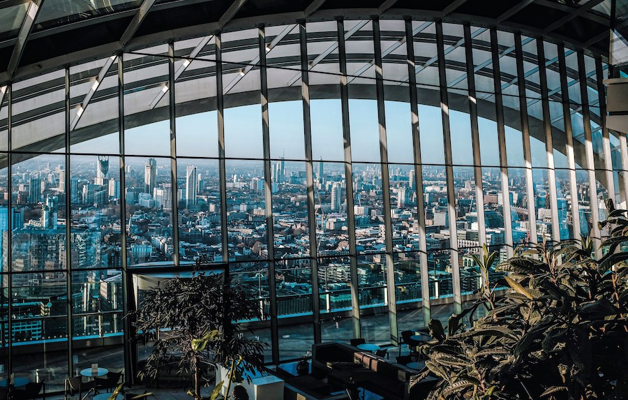 This is an image of the view you get from Sky Garden of London City. There are lots of buildings and plants around.