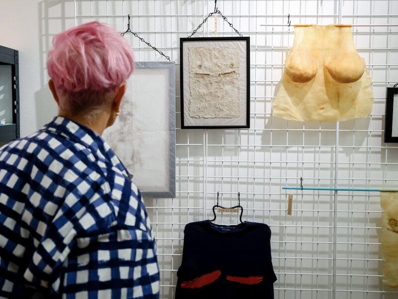 This is an image of a person looking at an exhibit at Queer Britain.