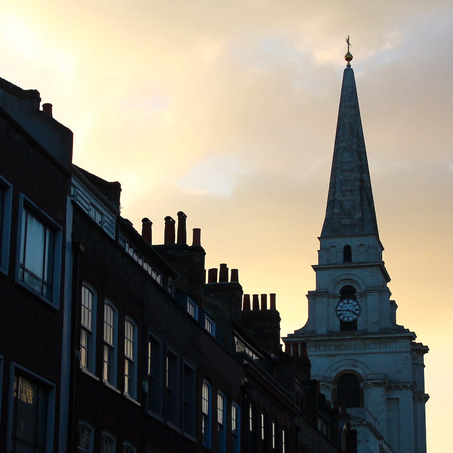 The evening sun overlooking a church in Whitechapel, that can be caught in one of the walking tours in London. Booking a tour for your friends is one of the best gift ideas for anyone visiting London
